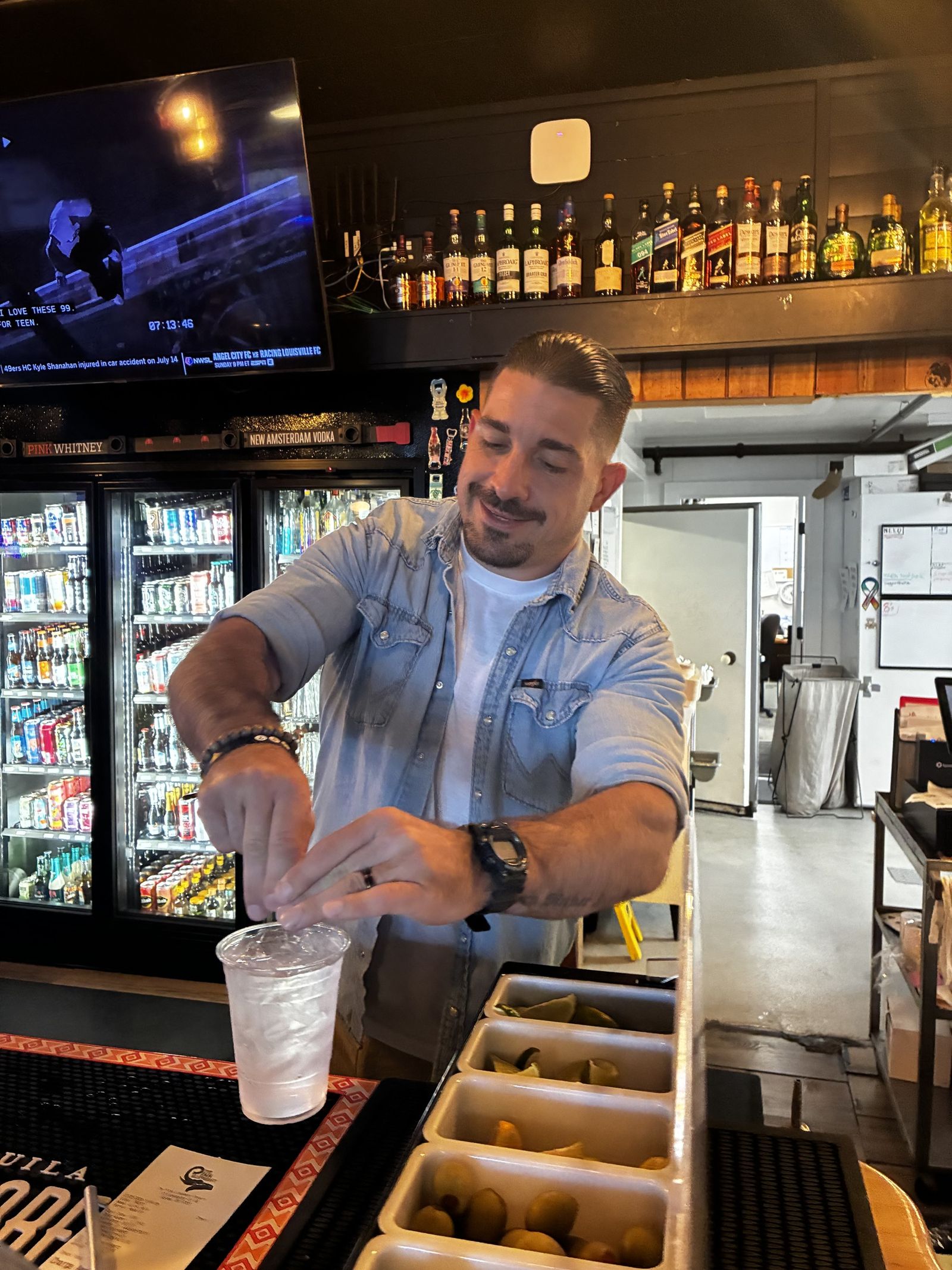 Bartender pouring a drink behind the bar