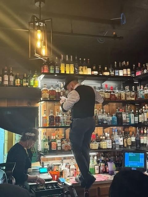 Bartender restocking the back bar