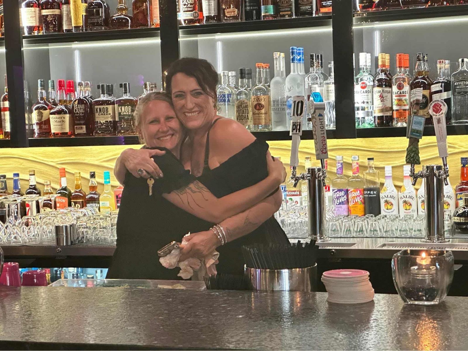 Two bartenders behind the bar