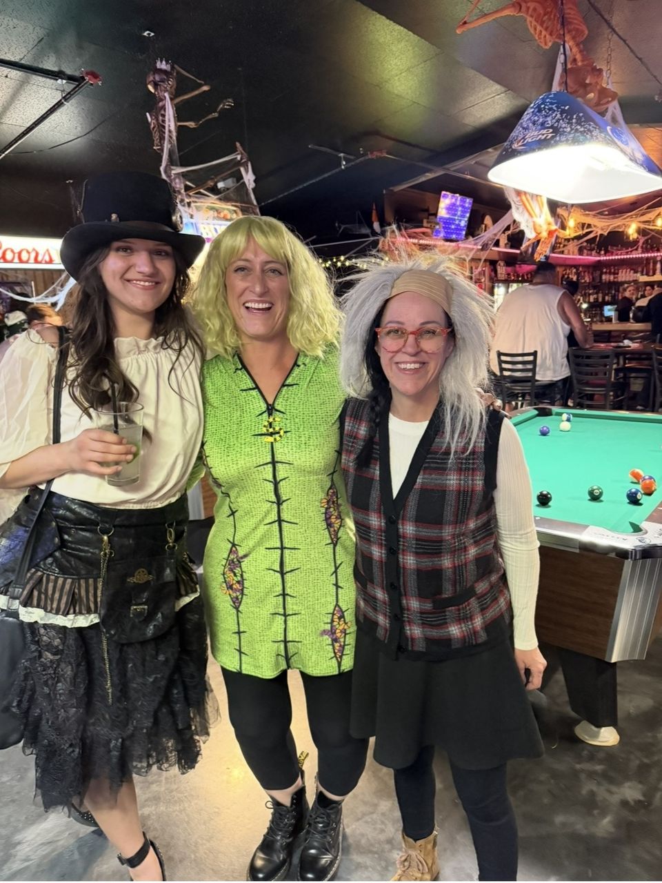 Costumed guests by the pool tables