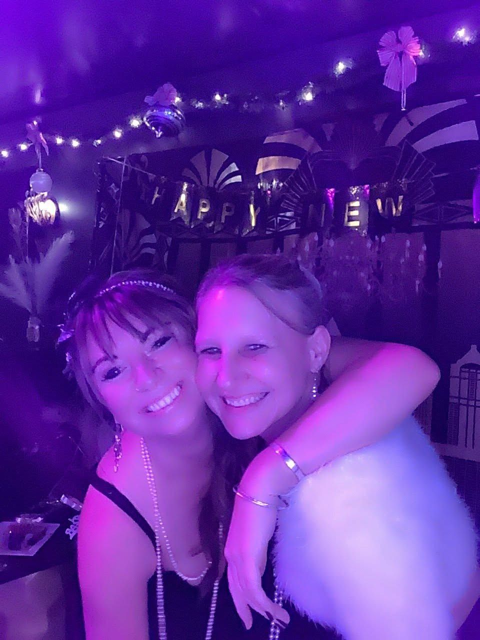 Friends in flapper dresses under purple lights