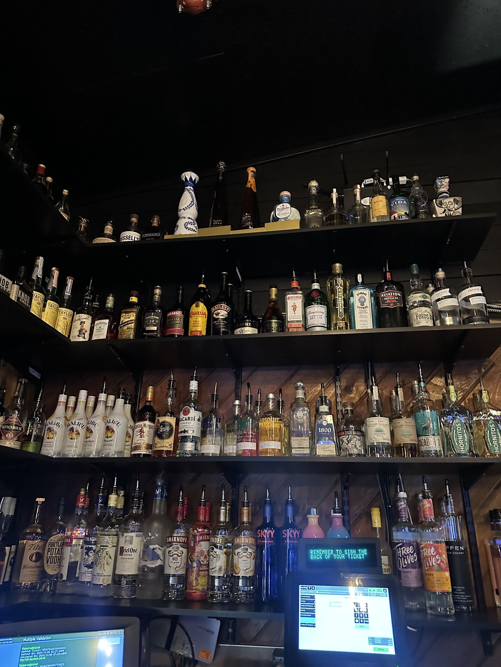 Shelves of bottles on the back bar