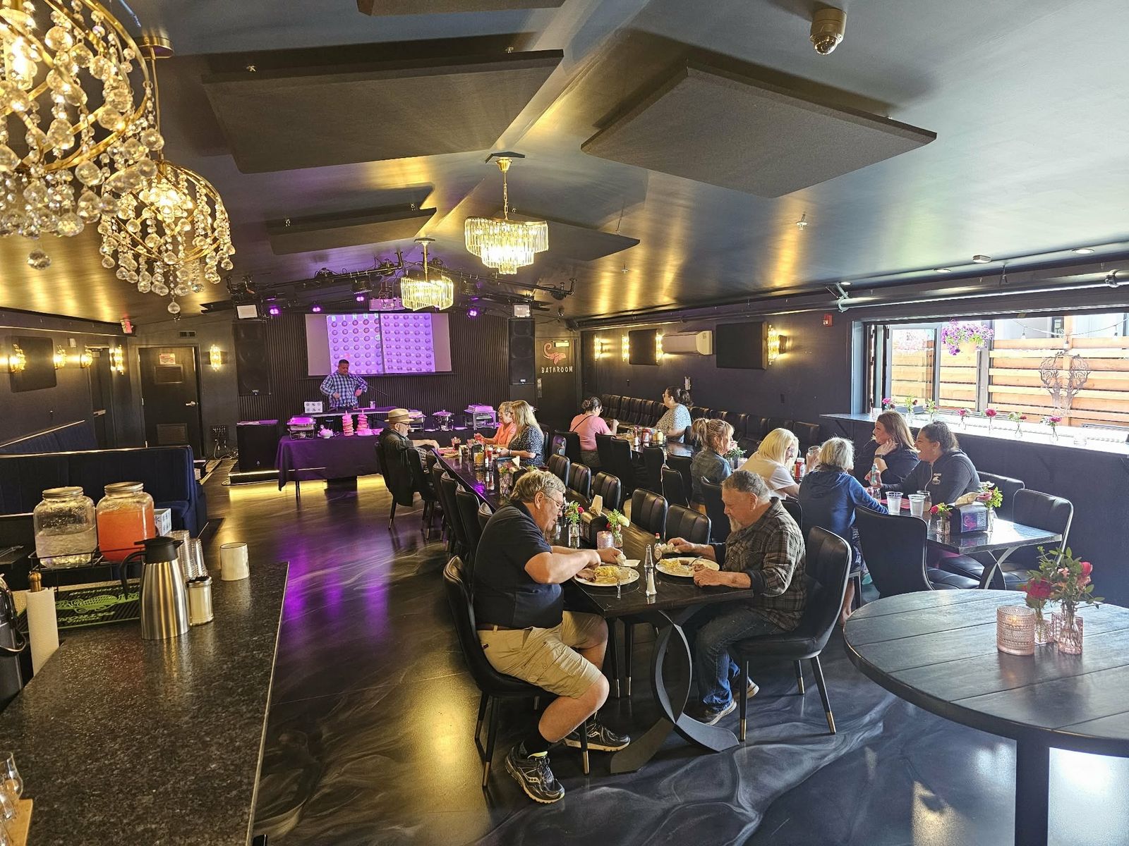 Guests in the dining room under the chandeliers