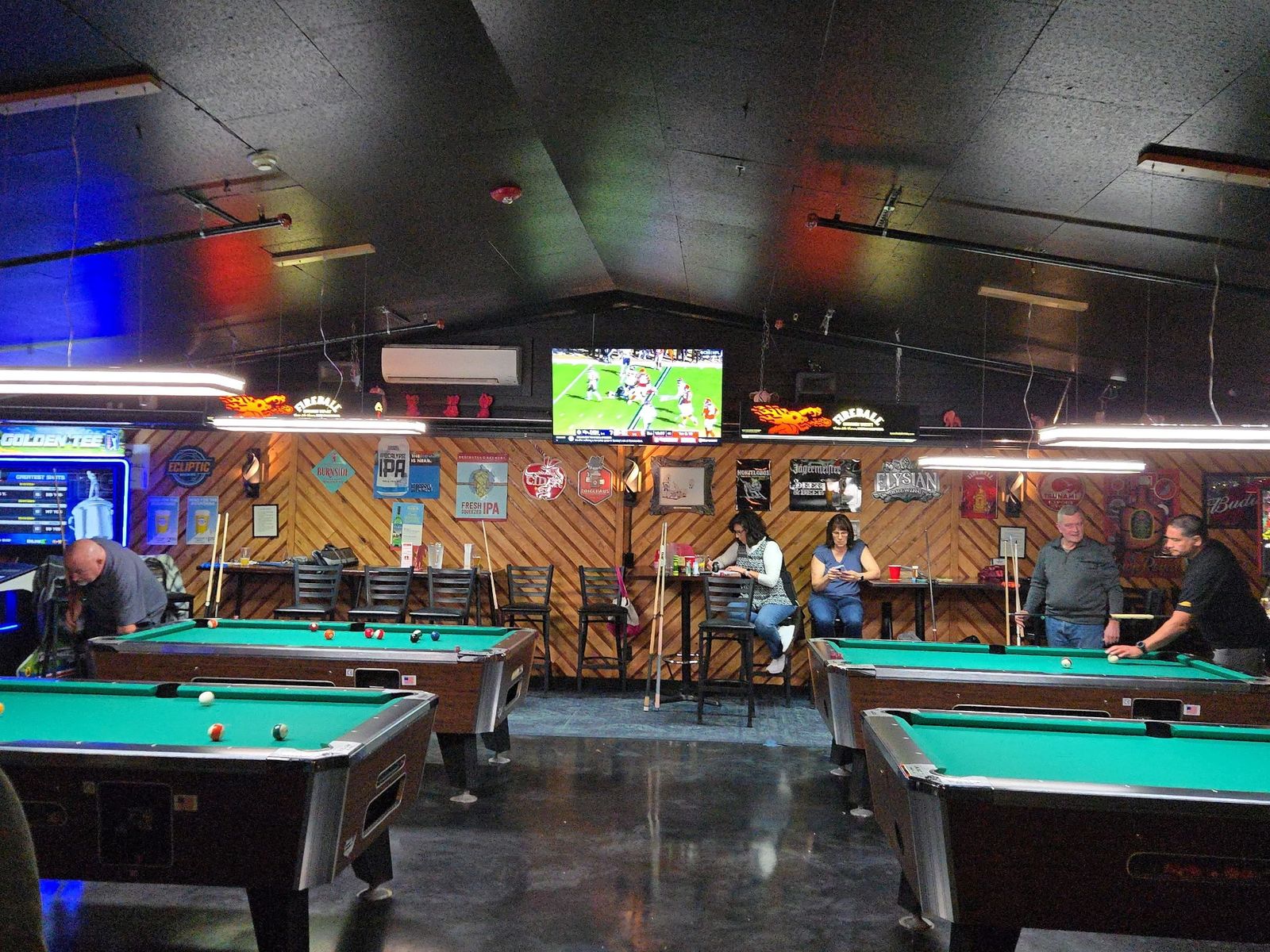 Pool tables and big screens in the game area