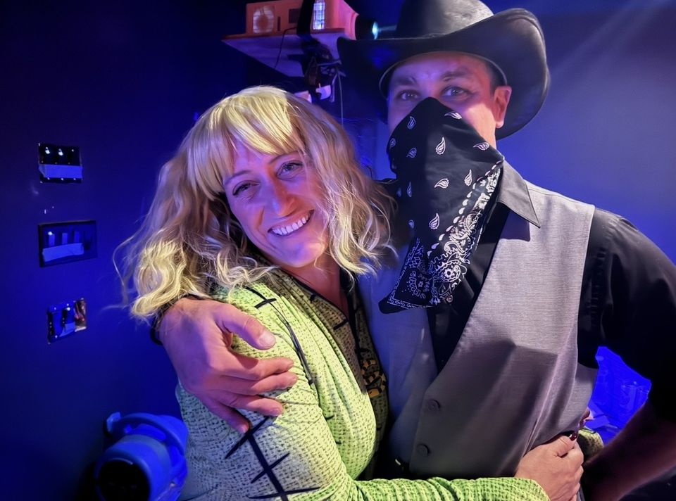 A couple dressed western for theme night